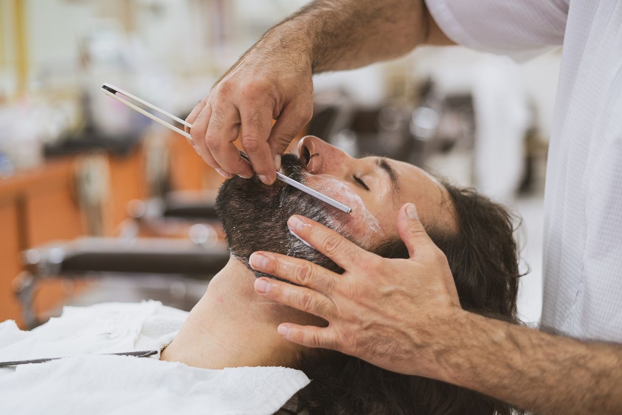 Barber giving a straight razor shave
